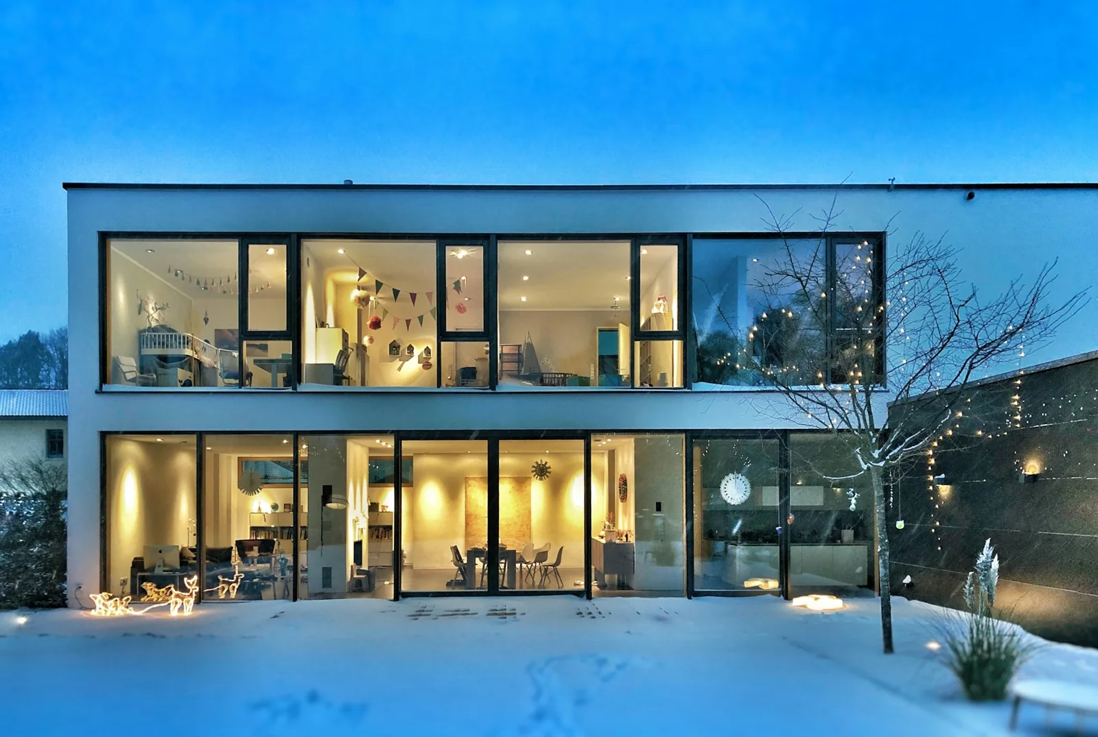 Architectural inspiration: a contemporary home with dark-framed windows at dusk